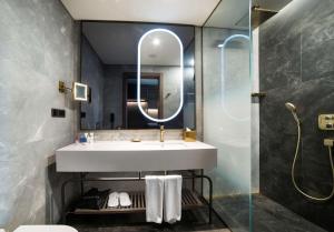 a bathroom with a sink and a mirror at Radisson Collection Hotel, Vadistanbul in Istanbul