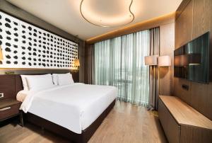 a bedroom with a large white bed and a large window at Radisson Collection Hotel, Vadistanbul in Istanbul