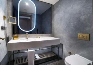 a bathroom with a sink and a mirror at Radisson Collection Hotel, Vadistanbul in Istanbul