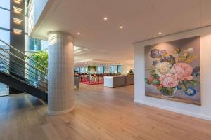 a lobby with a painting of flowers on the wall at Radisson Blu Hotel Amsterdam Airport, Schiphol in Schiphol