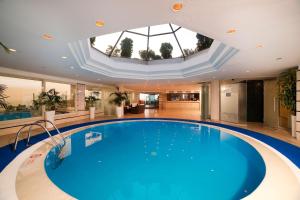 a large swimming pool in a building with a skylight at Radisson Hotel President Old Town Istanbul in Istanbul