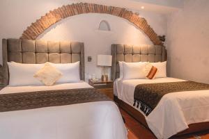 En eller flere senge i et værelse på Casa Eva Hotel Boutique & Spa
