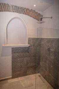 a bathroom with a shower with a glass door at Casa Eva Hotel Boutique & Spa in Cholula