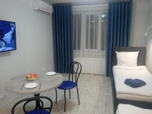 a small room with a table and a bed at Apartament YesCity! in Uzhhorod
