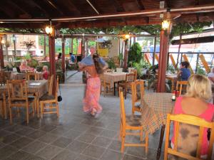 a man and a woman walking through a restaurant at Gerdjika Hotel in Nesebar