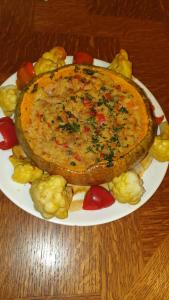 a plate of food with a pie on a table at Pensiunea Agroturistica Cerna, Vaideeni, Valcea in Vaideeni