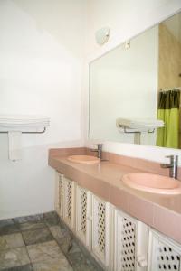 a bathroom with two sinks and a large mirror at Hotel Olinalá Diamante in Acapulco