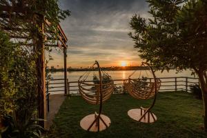 a view of a sunset with two hanging baskets at Phka Kravan Boutique in Kampot