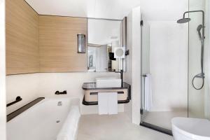 
a bathroom with a sink, toilet and bathtub at Harbour Grand Kowloon in Hong Kong
