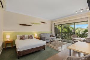a bedroom with a bed and a living room at Ballina Beach Resort in Ballina