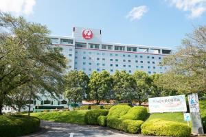 a large building with a sign in front of it at Hotel Nikko Narita in Narita