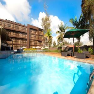 a large swimming pool in front of a building at Boma Inn Eldoret in Eldoret