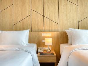 Ένα ή περισσότερα κρεβάτια σε δωμάτιο στο Hotel Fuse Rayong
