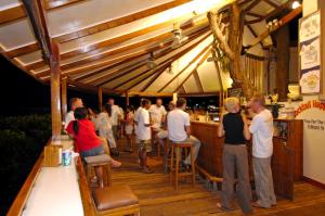 a group of people standing at a bar at El Galleon Beach Resort in Puerto Galera