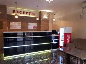 a restaurant with a reception desk and a sign that reads recycle at Hotel Uranus in Bucharest