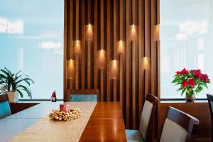 a dining room with a table with chairs and lights at Hotel Buchenland in Gura Humorului