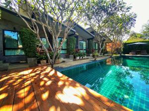 a house with a swimming pool and a wooden deck at Family House Zen Boutique Resort in Pai