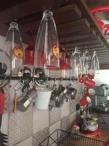 a kitchen with many glass bottles hanging from a wall at Agriturismo Cailuca in Pietralunga