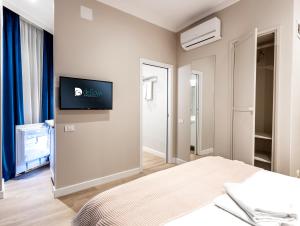 a bedroom with a bed and a flat screen tv on the wall at DeGoya Studios Bucharest Old Town in Bucharest