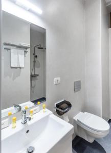 a white bathroom with a sink and a toilet at DeGoya Studios Bucharest Old Town in Bucharest