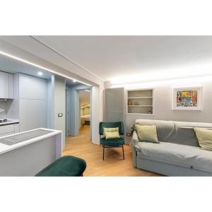 a living room with a couch and a kitchen at SUITE 168 in Pescara