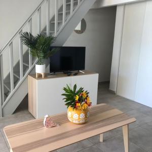 a living room with a coffee table with a tv and a table sidx sidx sidx at V2 Dream panorama of the ocean in Oyster Pond