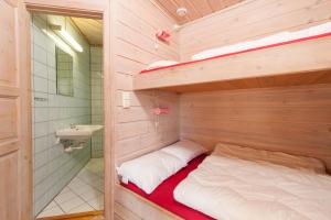 a bedroom with a bunk bed and a sink at Hamre Familiecamping in Kristiansand