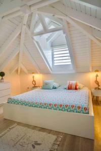 a bedroom with a large bed in a attic at V4 Magical view of the ocean and Saint Barth in Oyster Pond +20 photos