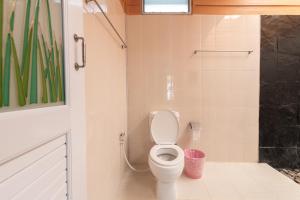 a bathroom with a white toilet in a room at บ้านสวนวารินทร์ รีสอร์ท in Pak Chong +30 photos