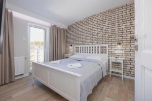 Ένα ή περισσότερα κρεβάτια σε δωμάτιο στο Apartamenty Słoneczne Tarasy by Noclegi Renters +62 φωτογραφίες