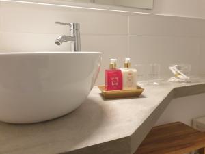 a bathroom counter with a white bowl sink and a faucet at Casa Tejo by Valada Village in Valada +42 photos