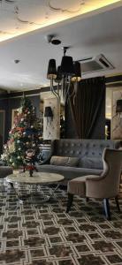 a living room with a christmas tree and a couch at Hermess Hotel Johor in Johor Bahru