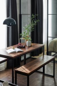 a table and bench with a book and plants on it at Staycity Aparthotels London Dalston in London