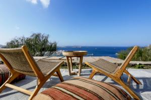 a couple of chairs and a table on a patio at Castle Panigirakis in Mikonos