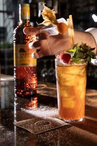 a drink on a counter with a bottle of alcohol at Hotel Maison FL in Paris