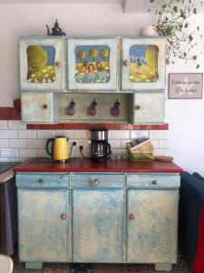 a kitchen with blue cabinets and a red counter top at Apartamenty Lavender Hill in Wisła