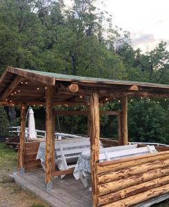 a wooden gazebo with a table on a deck at Agriturismo Al Castagno in Abetone