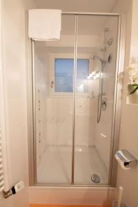 a shower with a glass door in a bathroom at Maigloeckerl in Grainau