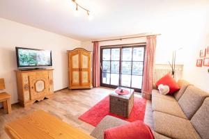 a living room with a couch and a television at Loewenzahn in Grainau