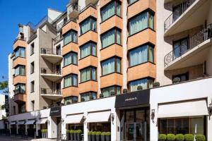 an apartment building with a brick facade at Hotel Maison FL in Paris