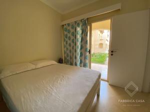 a bedroom with a bed and an open door at One bedroom Comfy Apartment by the sea, in Oriental Coast in Marsa Alam City