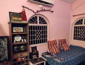 a living room with a bed and a shelf at Anjuna Hideout in Anjuna
