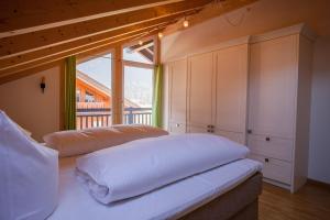 a bedroom with a bed and a large window at Rundblick in Farchant