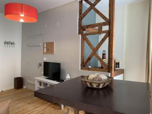 a living room with a table and a television at Bairro Alto apartments in Lisbon