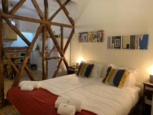 a large white bed in a room with wooden beams at Bairro Alto apartments in Lisbon