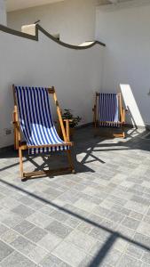 two blue and white chairs sitting in a room at La Primavera in Anacapri