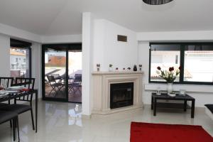 a living room with a fireplace and a table with flowers at Wondrous Terrace Apartment in Cascais Center in Cascais