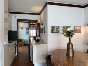 a kitchen and dining room with a table in a room at FLH Cascais Charming Old Town in Cascais