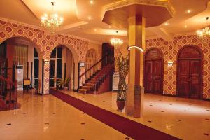 a large lobby with a staircase and a lobby at Mixt Royal Palace in Samarkand