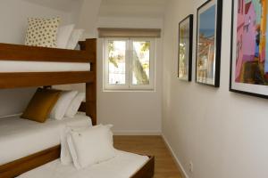 a bedroom with two bunk beds and a window at Love apartment Beco Torto, Cascais in Cascais